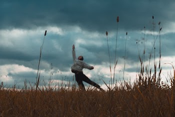 Blurred Photo of a Man  on Grass Field