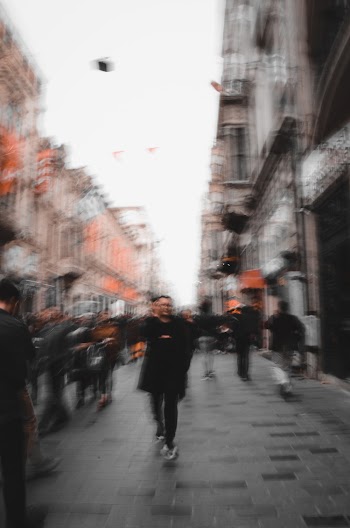 Blurred photo of people walking on street 