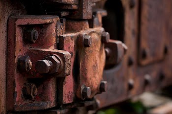 Blurry Photography of Red Metal Auto Part
