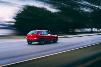 Blurry Vision of a Red Vehicle
