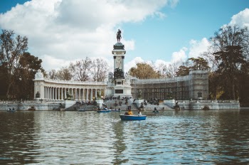 Boat in Water and Building With Statue