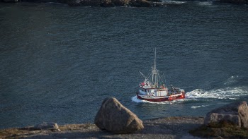 Boat Moving on Water Near Rock
