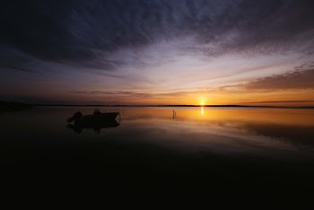 Boat on Body of Water during Sunrise