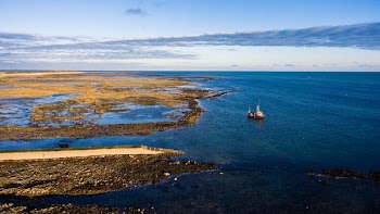 boat on body of water near island