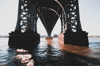 Boat Passing Under Bridge