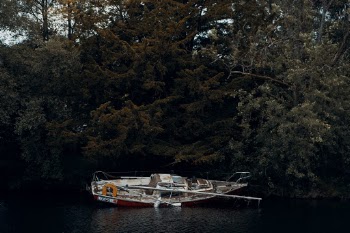 Boat sitting abandoned and broken.