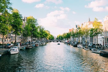 Boats Docked On Side Of River