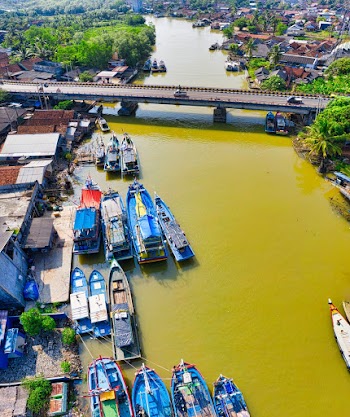 Boats Docked On The Riverside