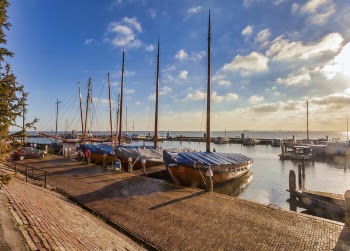Boats Near Dock Under Gray Sky