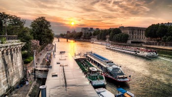 Boats on a River Next to Buildings