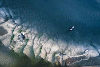 Boats on Body of Water and Shore during Day