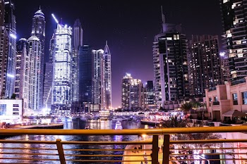 Boats on Body of Water Surrounded by High Rise Buildings