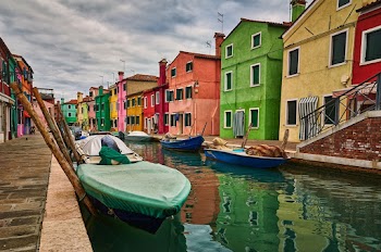 Boats on River Docked by the Roadside Near Assorted-color Houses