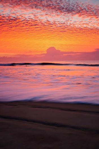 Body of Water Across Horizon during Sunset