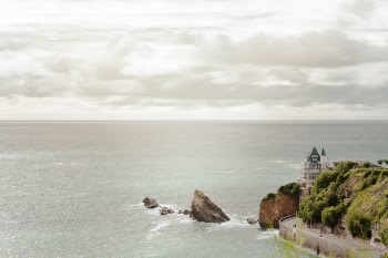 Body of Water and Gray Concrete Watchtower