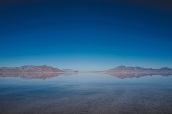 body of water and mountains during daytime