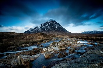 body of water at the foot of mountain