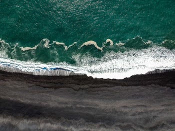 Body of Water Beside Black Soil