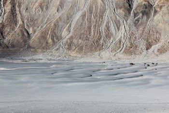 body of water beside mountain