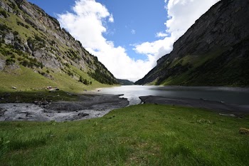 Body of Water Beside Mountain