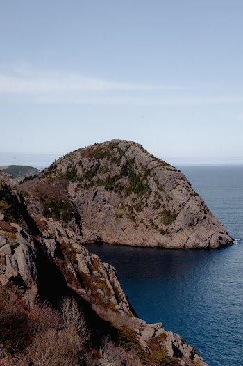 Body of Water Beside Rock Formation