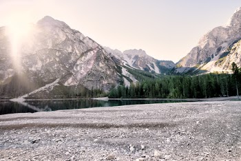 Body of Water Beside Trees and Mountain