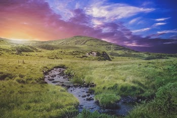 Body of Water Between Grass Field