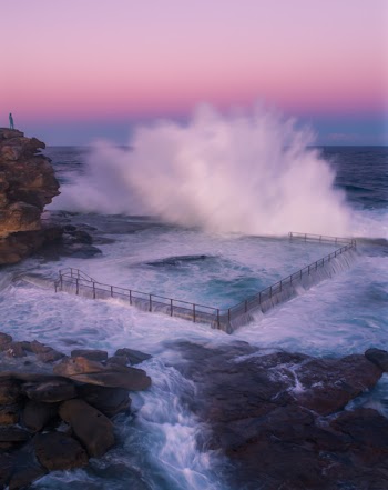 Body of Water Crashing on Black Steel Fence