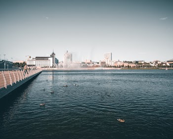 Body of Water, Handrail, and Buildings during Day