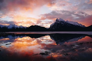 body of water in front of mountain ranges