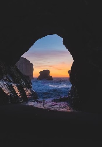 body of water near cave