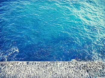 Body of Water Near Concrete Surface