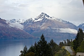 body of water near mountain at daytime