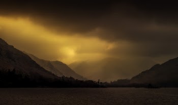 Body Of Water Near Mountains During Golden Hour