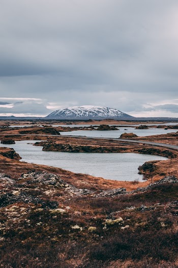Body of Water Near Snow-capped Mountain