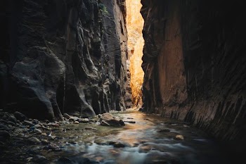 body of water on ridge between two rock formations