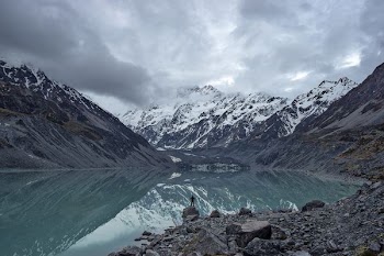 body of water overlooking mountains during daytime