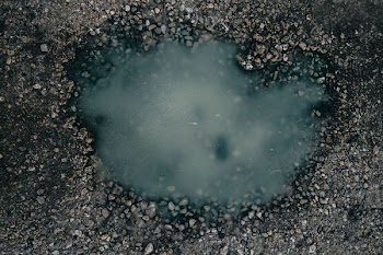 body of water surrounded by brown stones
