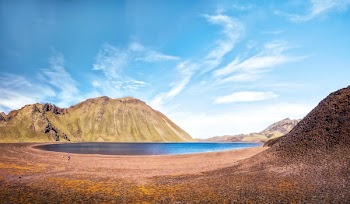 Body of Water Surrounded by Mountains