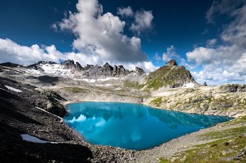 body of water surrounded by rocky mountains