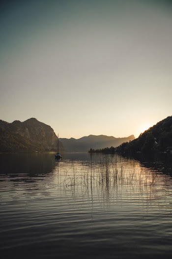 Body of Water Surrounded With Mountain