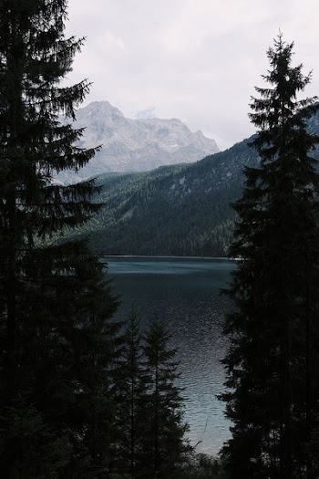 body of water surrounded with mountain