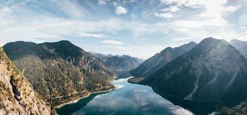 Body of Water Surrounded With Mountains
