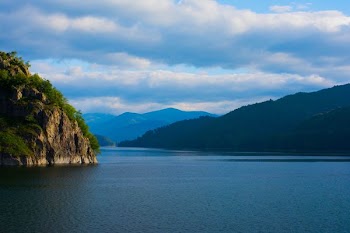 body of water surrounded with rock formation