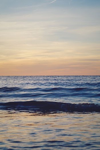 body of water under blue sky