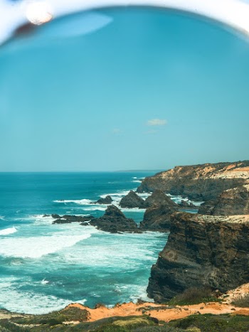 Body of Water Under Blue Sky