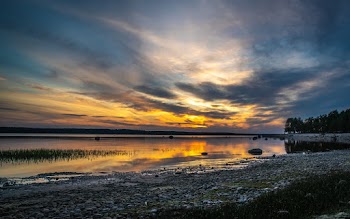 Body of Water Under Brown and Blue Sky at Golden Hour