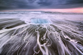 body of water under cloudy sky