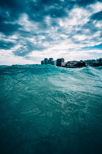 Body of Water Under Cloudy Sky