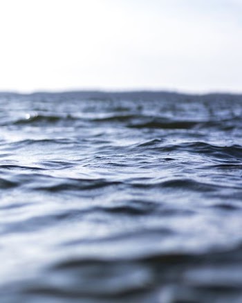 body of water under cloudy sky
